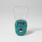 Blue rhinestone-encrusted digital clock on a wooden surface