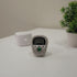 Digital timer with bling on a stand next to a potted plant