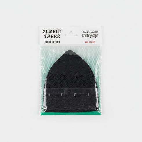 A packaged black mesh knitting cap from the Zürürüt Takre Gold Series, sealed in clear plastic with a white paper header card, resting on a speckled countertop.