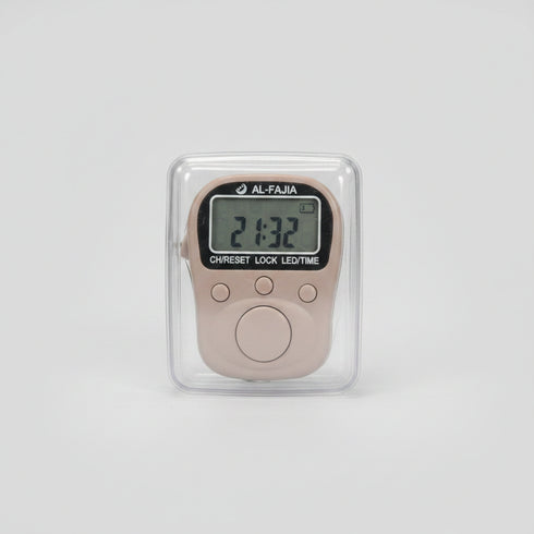 A small digital lock timer with a gray LCD screen and round buttons, shown inside a clear plastic protective case and held by a hand. The background is a blurry indoor desk environment.