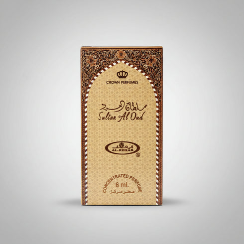 A hand holding a 6 ml box of Crown Perfumes Sultan Afnan concentrated perfume, featuring a beige and gold patterned design with brown ornate borders.
