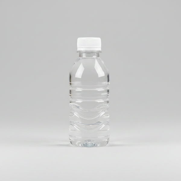 Hand holding a clear bottle with a white cap against a neutral background